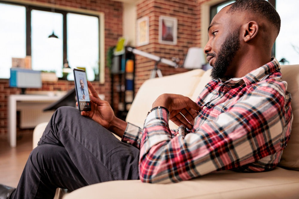 Man exploring why addiction affects everyone differently during virtual therapy session