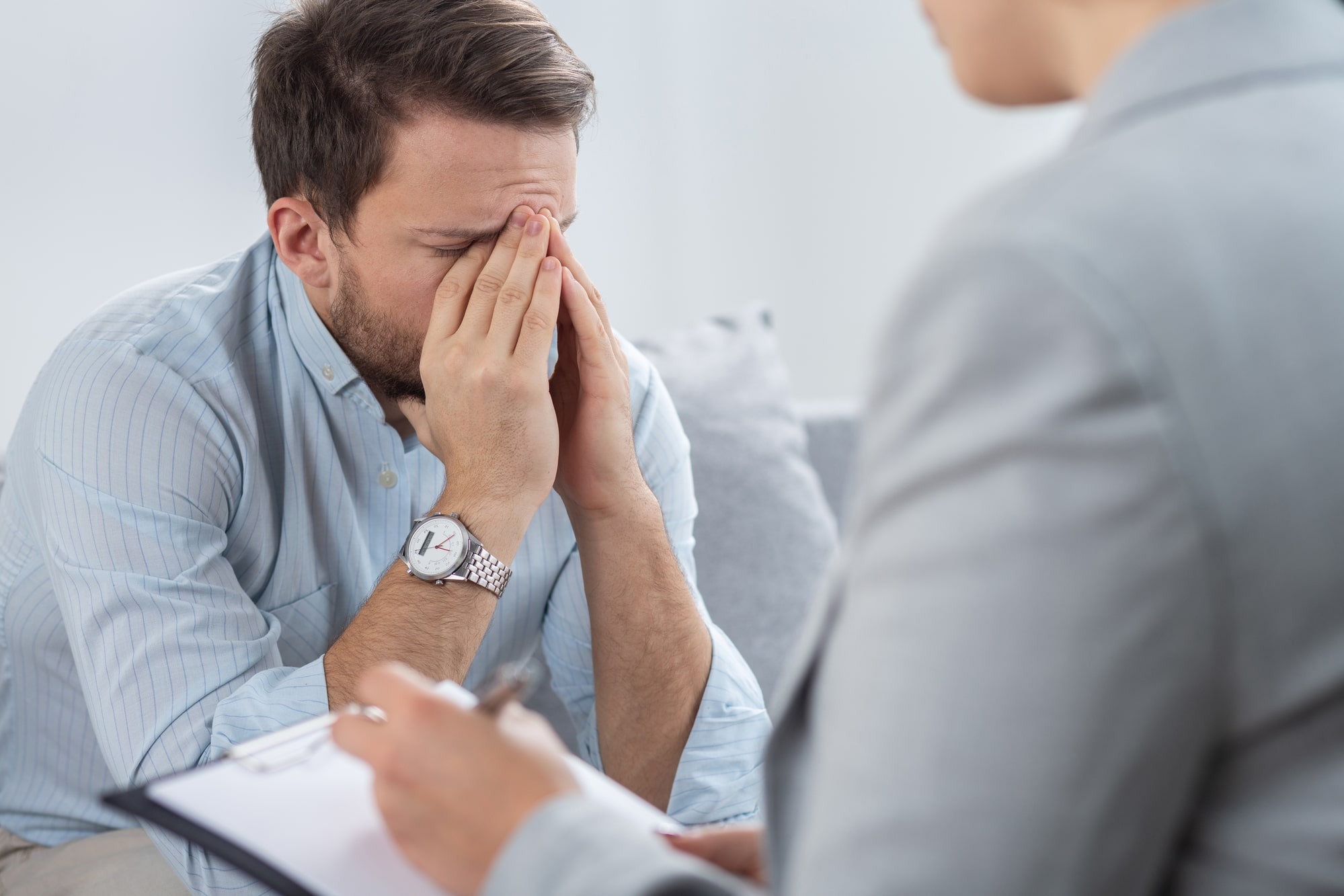 a man struggling in trauma therapy