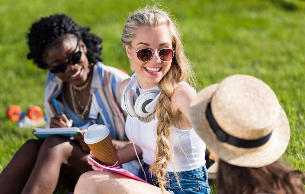 Young woman managing ptsd flashback through positive social interaction outdoors