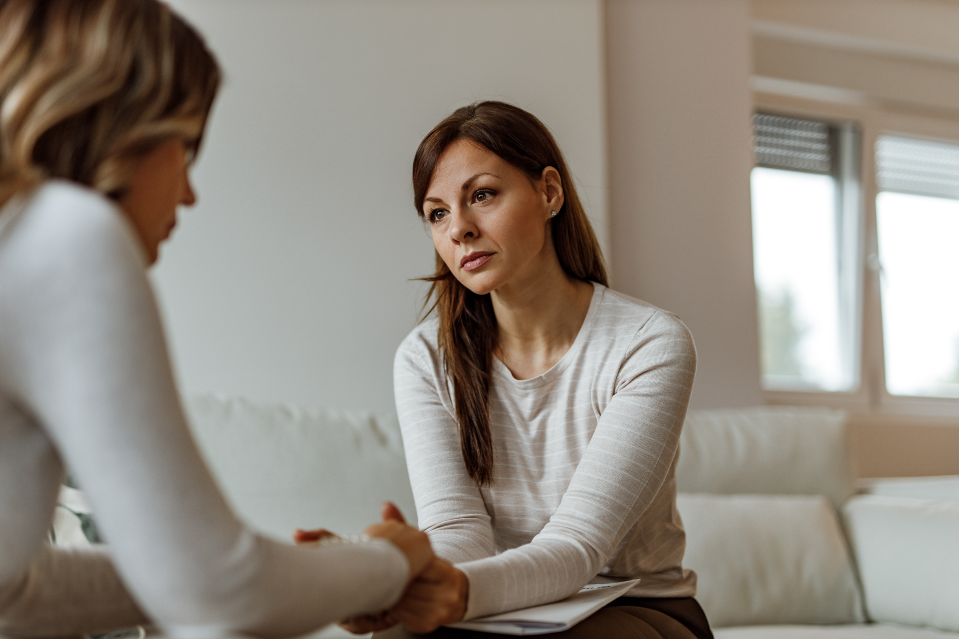 Helping about solving her problems with mental health. woman in therapy sitting on couch
