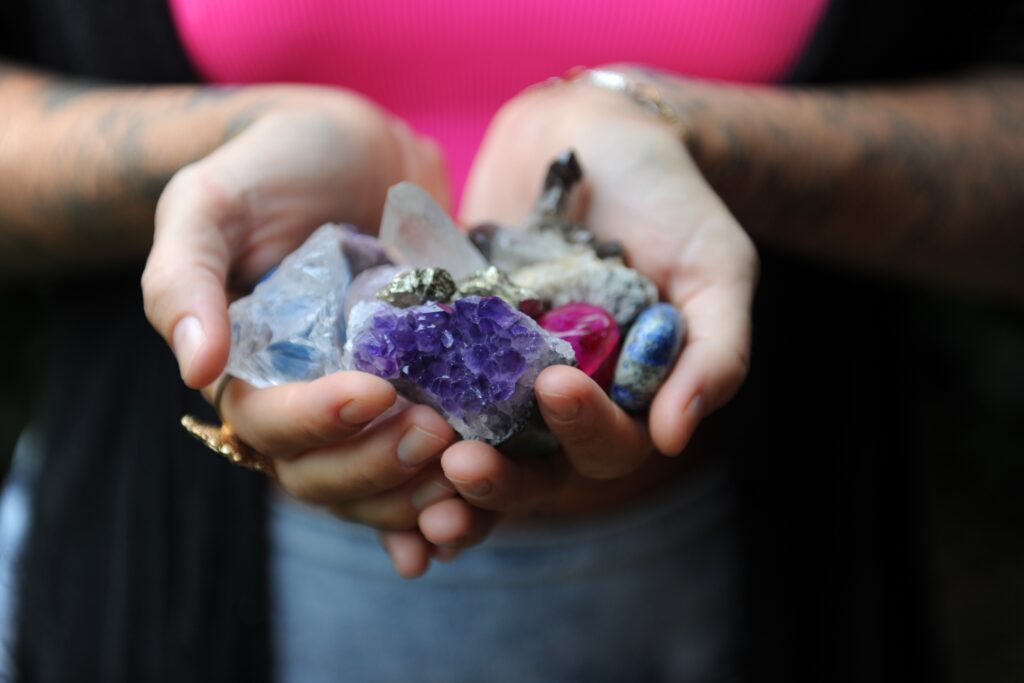 a hand holding different types of crystals