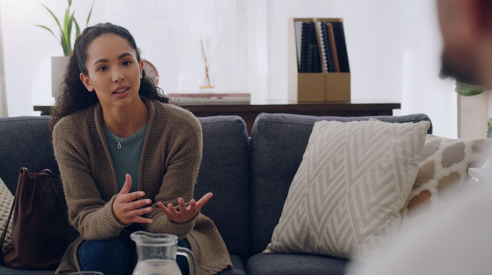Young woman in trauma therapy session discussing emotional recovery