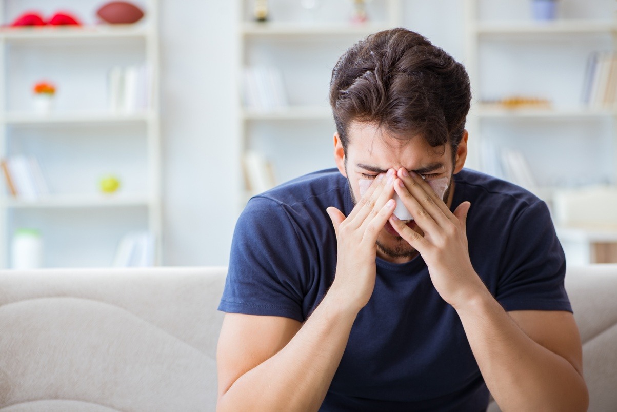 a man showing sign he is in pain
