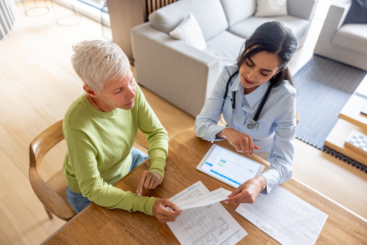 Clinician reviewing treatment paperwork with a client during a private care planning conversation.