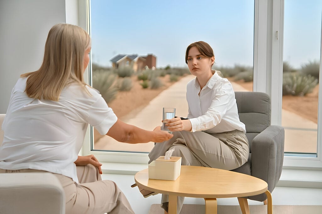 Therapist supporting a client during a calm trauma-first treatment session.
